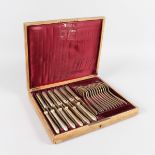 A SET OF TWELVE RUSSIAN TABLE KNIVES AND FORKS by KHLEBNIKOV, CIRCA. 1881, in original case. Stamped