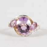 A GOOD AMETHYST AND DIAMOND DRESS RING in 18ct yellow gold.