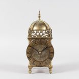 A SMALL BRASS LANTERN CLOCK with French movement. 9.5ins high.