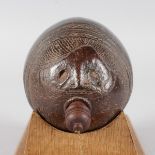 A 19TH CENTURY PARTIALLY CARVED COCONUT FLASK AND STOPPER. 6.5ins.