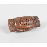 A GOOD COQUILLA NUT CARVED SNUFF BOX carved with motifs and figures. 8.5cms long.
