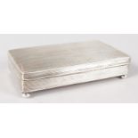 A CONTINENTAL RIBBED SILVER BOX, on four bun feet. 4.75ins long.