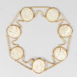 A SUPERB GOLD BRACELET set with SEVEN CARVED CHINESE MOTHER-OF-PEARL OVALS.