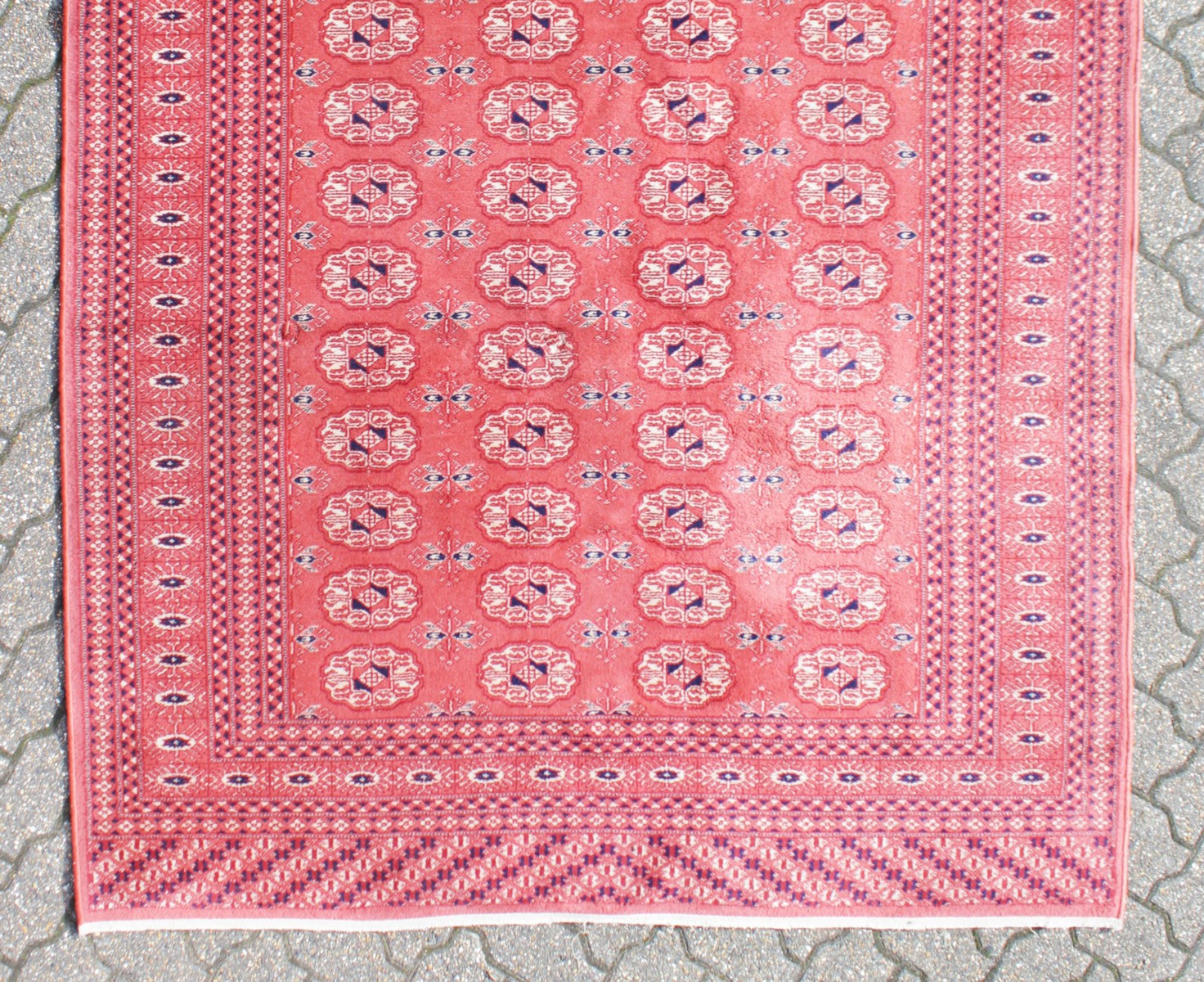 A BOKHARA CARPET, claret ground within lozenge border. 7ft 7ins x 5ft 5ins. - Image 2 of 4