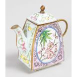 A SMALL CHINESE ENAMEL TEAPOT AND COVER, painted with panels of flowers. 9cms.