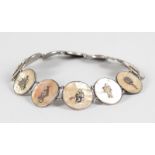 A CHINESE SILVER BRACELET, set with twelve circular mother-of-pearl plaques.