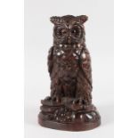 A GOOD CARVED WOOD BLACK FOREST STANDING OWL TOBACCO JAR with hinged head and glass eyes. 11.5ins