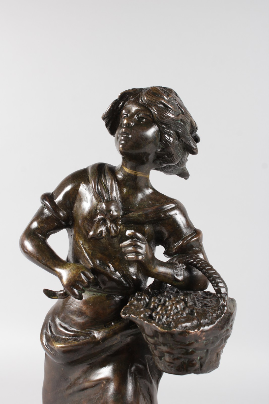 A 19TH CENTURY FRENCH BRONZE OF A YOUNG WOMAN carrying a basket of fruit and standing on a - Image 2 of 5