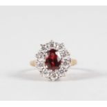 A GARNET AND BRILLIANT 9CT YELLOW GOLD DRESS RING.