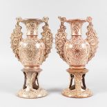 A PAIR OF UNUSUAL LUSTRE ISLAMIC VASES AND STANDS with a long pair of handles and tapering body,