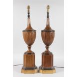 A PAIR OF REGENCY STYLE TOLEWARE URN SHAPED PEDESTAL LAMPS. 2ft 2ins high.