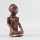 A SEATED TRIBAL FUNERARY FIGURE with original bead necklace. 5.5ins high.