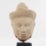 A KHMER COLUMBIAN STONE HEAD. 8ins high.