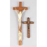 TWO CRUCIFIXES, one bone, the other inlaid with mother-of-pearl. 16ins long and 7ins long.