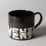 A WEDGWOOD JASPER WARE SPORTING MUG, designed by RICHARD GUYATT, No. 192 of 500.