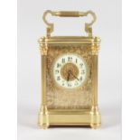 A GOOD 19TH CENTURY FRENCH BRASS CARRIAGE CLOCK with reeded column sides and filigree face. 6.