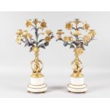 A GOOD PAIR OF LOUIS XVI PATTERN ORMOLU AND WHITE MARBLE FOUR LIGHT CANDELABRA, formed as cupids