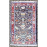 AN UNUSUAL ORIENTAL RUG, blue ground with vase motifs, with red motif border. 6ft 6ins x 4ft.