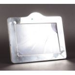 A PLAIN RECTANGULAR PHOTOGRAPH FRAME with serpentine top. 7ins x 8.5ins.