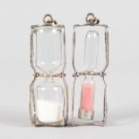 A PAIR OF SILVER EGG TIMER PENDANTS.
