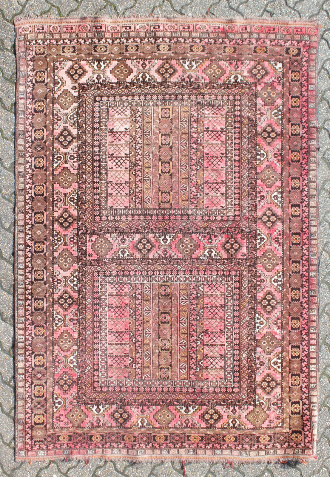 A PERSIAN CARPET, red ground with double central pattern, floral border. 7ft 6ins x 5ft 6ins.