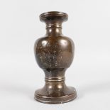 AN ORIENTAL BRONZE VASE engraved with calligraphy. 15cms high.