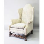A QUEEN ANNE STYLE UPHOLSTERED WING ARMCHAIR, 20TH CENTURY, with high back, outward curving arms, on