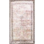 A SILK KASHMIR RUG, pink ground with hunting scenes and leopards. 8ft x 5ft 9ins.