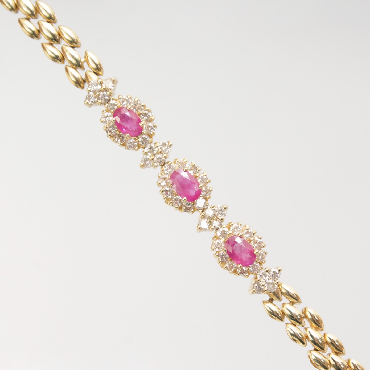 AN 18CT YELLOW GOLD, RUBY AND DIAMOND BRACELET.