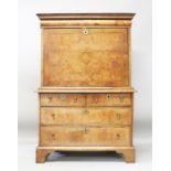A QUEEN ANNE WALNUT ESCRITOIRE, with cushion drawer above a fall front, fitted interior over a
