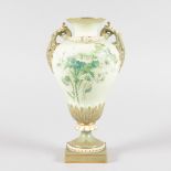 A ROYAL WORCESTER BLUSH GREEN TWO HANDLED VASE, painted with thistles in Raby style.