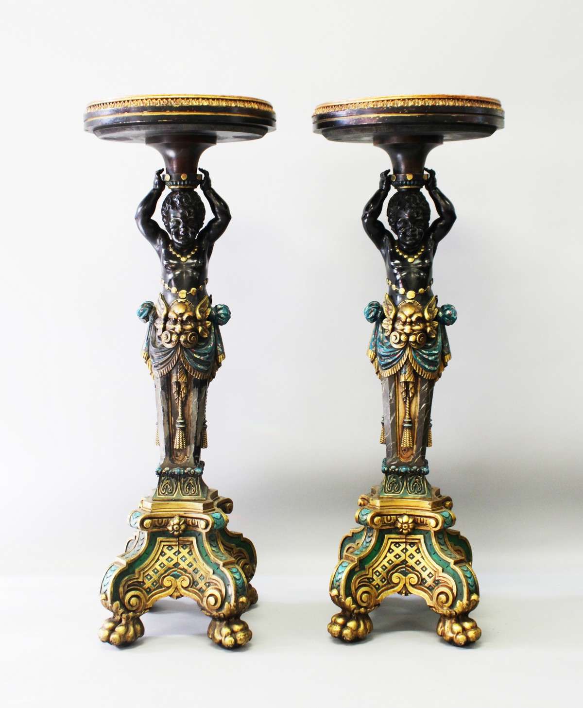 A SUPERB PAIR OF CARVED PAINTED AND GILDED BLACKAMOOR STANDS, the tops inset with a malachite panel,