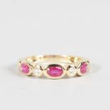 A RUBY AND DIAMOND HALF HOOP RING set in 18ct yellow gold.