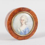 A SMALL CIRCULAR PILL BOX, the lid with a lady in a blue dress. 2.75ins diameter.