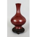 A FINE QUALITY 18TH CENTURY CHINESE IRON RUST GLAZED PORCELAIN VASE, together with a carved wood