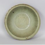 A CHINESE YUAN/MING DYNASTY LONGQUAN CELADON SHIPWRECK STONEWARE DISH, the interior centre carved