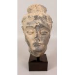 AN INDIAN GREY GANDHARA SCHIST STONE HEAD OF A BODHISATTVA, possibly early, mounted on a square