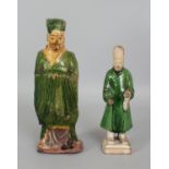 TWO CHINESE MING DYNASTY POTTERY TOMB FIGURES, each partially applied with a green glaze, 10.5in(