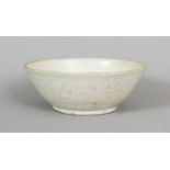 A CHINESE DING WARE PORCELAIN BOWL, Song Dynasty or later, the exterior sides with white slip