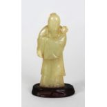 AN 18TH/19TH CENTURY CHINESE CELADON JADE FIGURE OF SHOU LAO, together with a fixed wood stand,