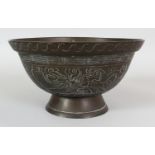 AN EARLY 20TH CENTURY CHINESE BRONZE BOWL, the sides decorated with a panel of a dragon and