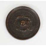 ANOTHER SMALL CHINESE BRONZE MIRROR, possibly early, the indistinct cast decoration including a