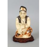 A CHINESE MING DYNASTY PAINTED CIZHOU FIGURE OF GUANYIN, together with a wood stand, the Goddess