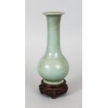 A CHINESE YUAN/MING DYNASTY LONGQUAN CELADON BOTTLE VASE, together with a fitted wood stand, the