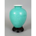 AN 18TH/19TH CENTURY CHINESE GREEN GLAZED PORCELAIN VASE, together with a fitted wood stand, the