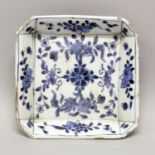 A CHINESE KANGXI PERIOD BLUE & WHITE PORCELAIN TEAPOT STAND, circa 1700, of chamfered square form,