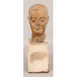 AN UNUSUAL STONE HEAD OF A MAN, possibly Graeco-Roman, the hair dressed, mounted on a stone