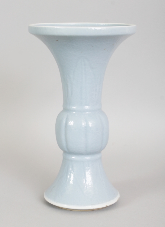 A 19TH CENTURY CHINESE CLAIRE-DE-LUNE PORCELAIN GU VASE, the sides moulded beneath the glaze with