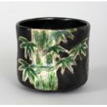 AN 18TH/19TH CENTURY JAPANESE BLACK GROUND POTTERY CHAWAN, attributed to Kenzan, the side