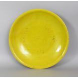 A LARGE 18TH/19TH CENTURY CHINESE YELLOW GLAZED PORCELAIN DISH, applied with a densely crackled